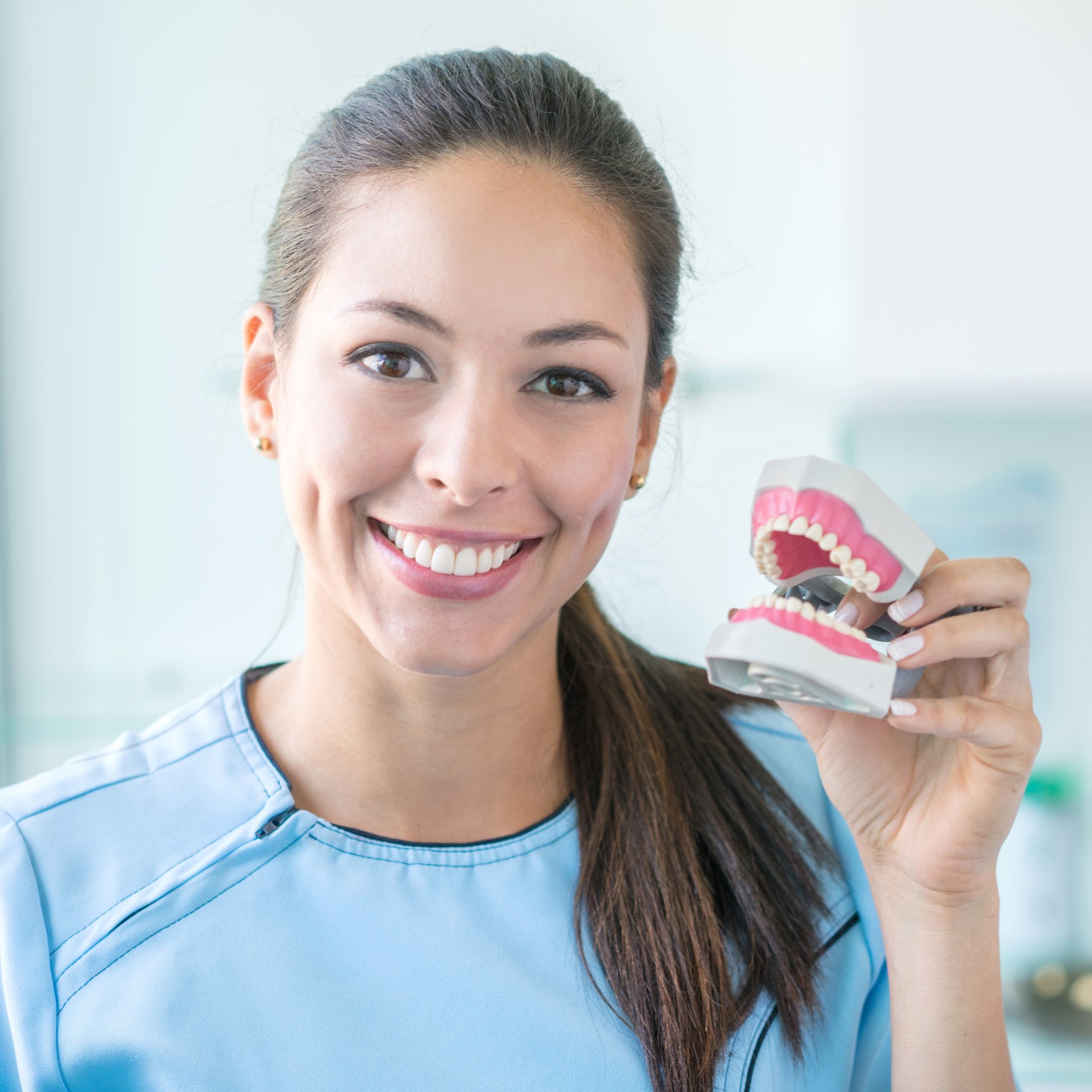 Dentist holding a denture Dentures